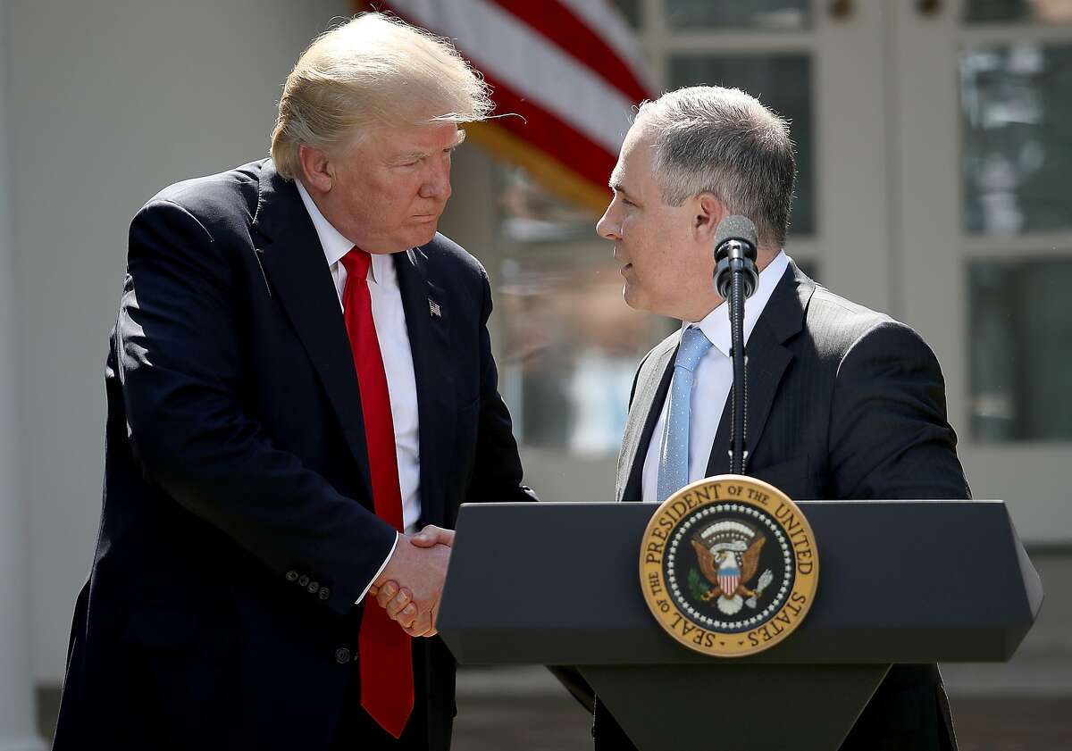 FILE - JULY 5, 2018: President Donald Trump has announced that Environmental Protection Agency chief Scott Pruitt has resigned July 5, 2018. WASHINGTON, DC - JUNE 01: U.S. President Donald Trump shakes hands with EPA Administrator Scott Pruitt after announcing his decision for the United States to pull out of the Paris climate agreement in the Rose Garden at the White House June 1, 2017 in Washington, DC. Trump pledged on the campaign trail to withdraw from the accord, which former President Barack Obama and the leaders of 194 other countries signed in 2015. The agreement is intended to encourage the reduction of greenhouse gas emissions in an effort to limit global warming to a manageable level. (Photo by Win McNamee/Getty Images)