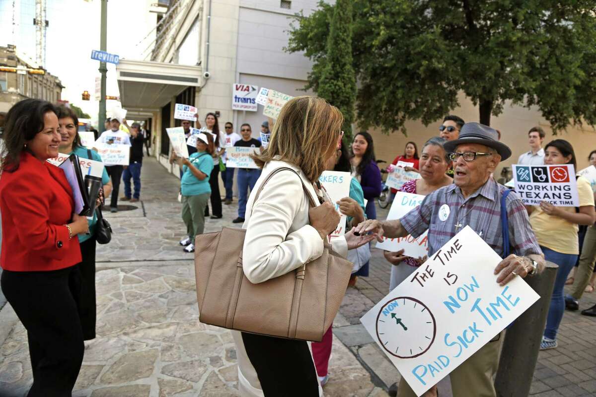 Councilwoman Shirley Gonzales greets Jesse R. Vidales who was with a small group of protesters calling for mandatory paid sick leave for workers in San Antonio last month.