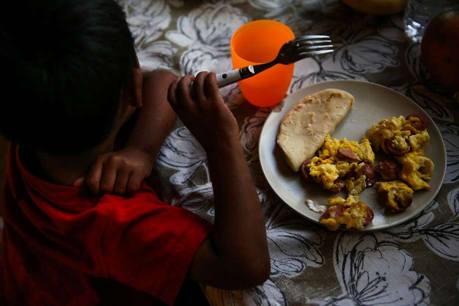 Jorgito, 5, eats dinner in the apartment he is staying in with his cousins in San Mateo, California, on Thursday, July 5, 2018. Jorgito was separated from his mother at the Texas border and she was since deported back to Guatemala. He is being cared for by his cousin Margarita. Photo: Gabrielle Lurie / The Chronicle