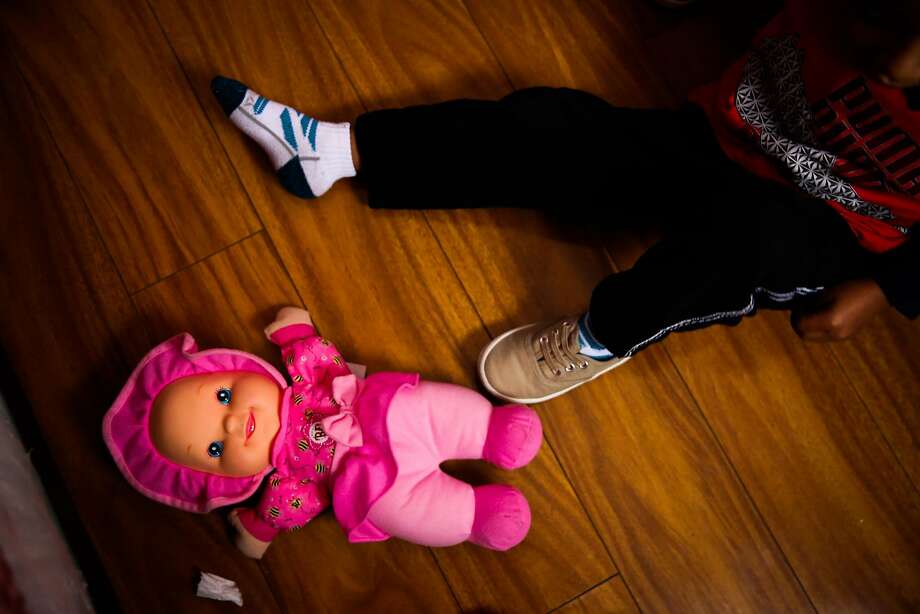 Jorgito, 5, sits on the ground as he plays with a doll in the apartment he is staying in with his cousins in San Mateo, California, on Thursday, July 5, 2018. Jorgito was separated from his mother at the Texas border and she was since deported back to Guatemala. He is being cared for by his cousin Margarita. Photo: Gabrielle Lurie / The Chronicle