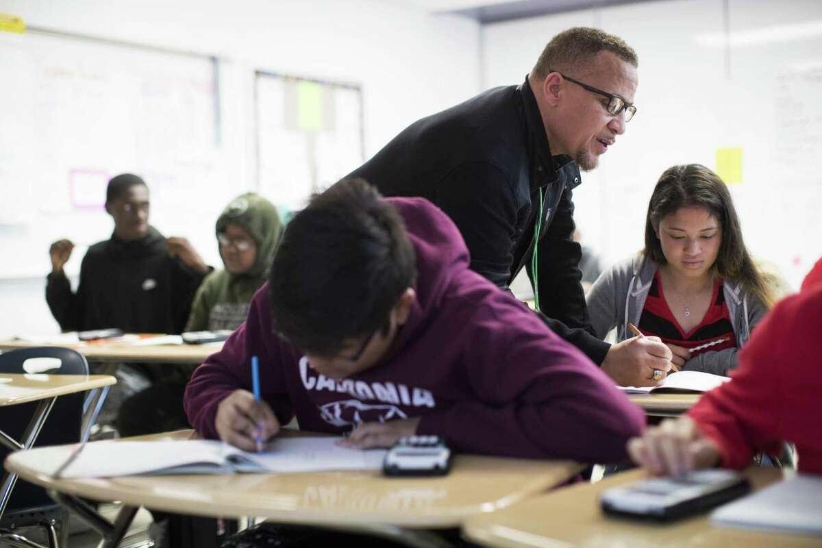 Worthing High School math teacher Michael Judge helps Hilda Martinez, 15, with questions during his Algebra I class on Thursday, April 5, 2018, in Houston. >>>See which Houston-area schools have the most experienced teachers in the photos that follow....
