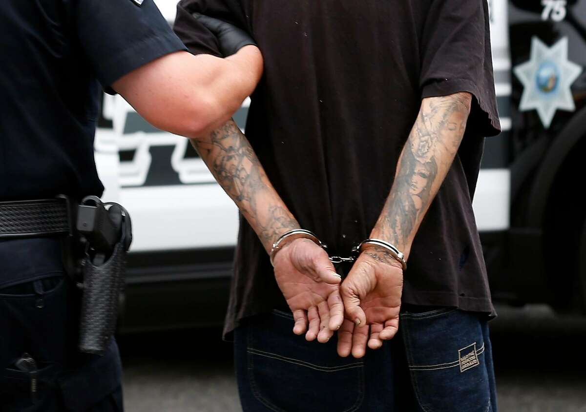 A man is taken into custody by police officers after a burglary was reported in Fairfield, Calif. on Friday, July 6, 2018. Homicide rates have declined throughout the Bay Area including Fairfield, the county seat of Solano County.