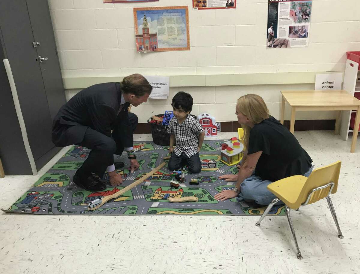 U.S. Sen. Richard Blumenthal, D-Conn., and volunteer Brenda DenOuden practice counting with 4-year-old Mohammed Friday at an Integrated Refugee & Immigrant Services summer learning program in New Haven.
