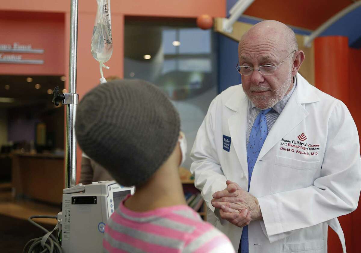 Dr. David Poplack speaking with a patient at Texas Children's Cancer and Hematology Centers in 2016, has stepped down as the center’s director to become associate director of its Africa outreach. ( Mark Mulligan / Houston Chronicle )