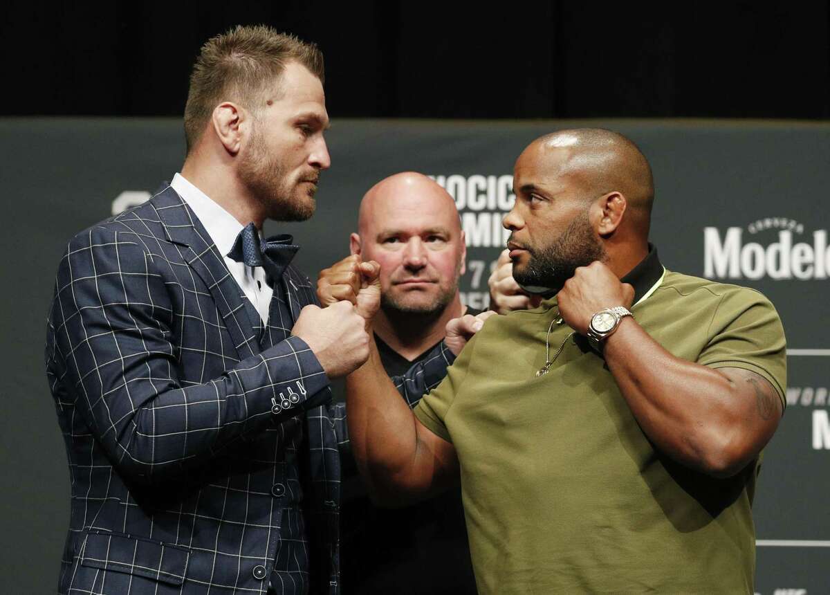 UFC president Dana White looks on as Stipe Miocic, left, and Daniel Cormier pose during a press conference Thursday in Las Vegas for UFC 226. They are scheduled to fight for the heavyweight title Saturday.