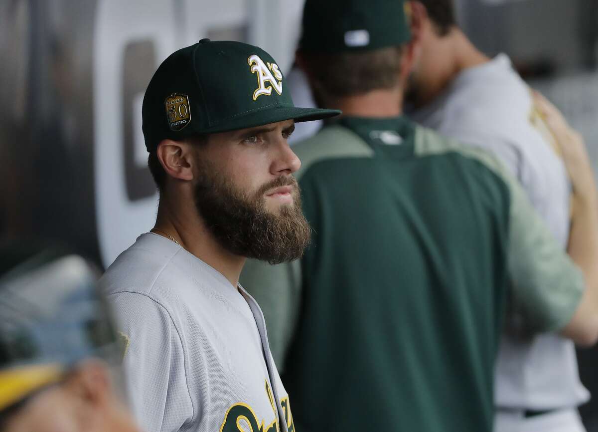 Oakland Athletics' Nick Martini looks to the field from the dugout during the seventh inning of a baseball game against the Chicago White Sox, Saturday, June 23, 2018, in Chicago. (AP Photo/Nam Y. Huh)