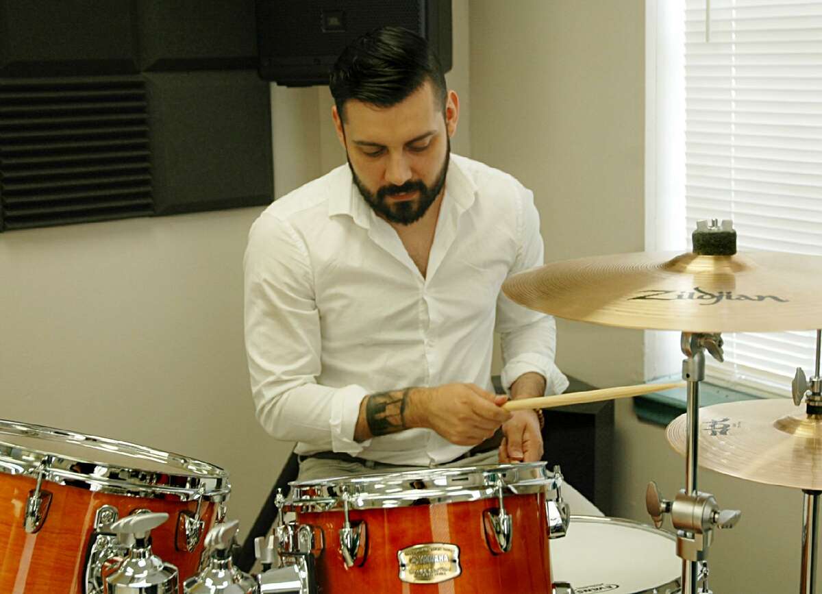 Jose Villa, instructor and co-founder of the Music Clubhouse, practices on the drums on Friday at the Lamar Bruni Vergara Boys and Girls Club of Laredo.
