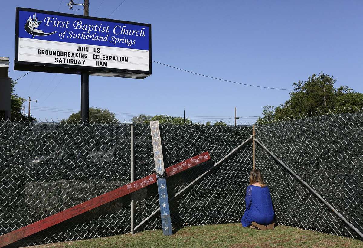 Sherri Pomeroy prays, along with many others, along the fence perimiter where Karla Holcombe prayer walked for years asking God to give the land to the church. Sherri paused to kneel in prayer at every corner, the boundries of the land now owned by the church, during the prayer walk which was part of First Baptist Church of Sutherland Springs' Groundbreaking Celebration on Saturday, May 5, 2018.