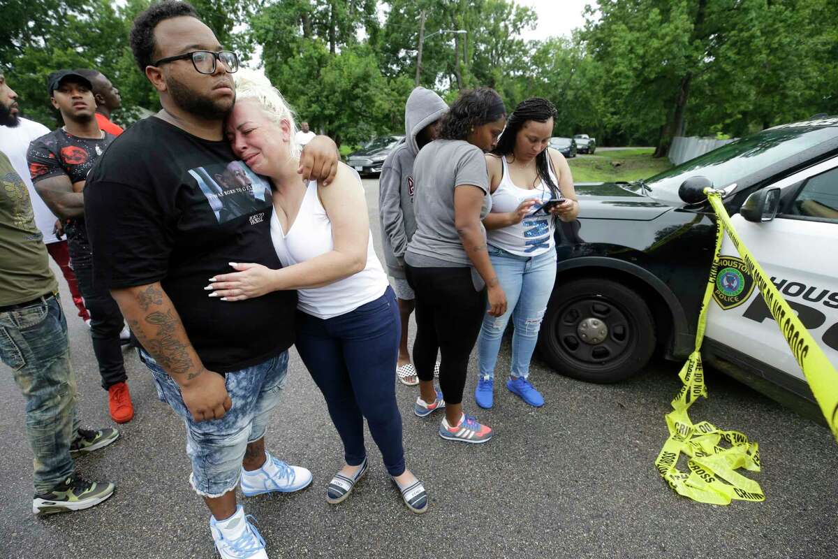 Suzanne Alvarado, center, is comforted as she and other family members and friends wait near the home of her cousin, Christopher Charles Williams Sr., where his two-year-old son, Christopher Charles Williams Jr. was shot July 8, 2018 in Houston. The boy was transported to the hospital but died from the accidental shooting.