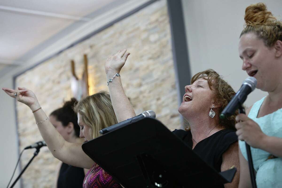 Sheri Kay sings with the worship team and congregation at First Baptist Church of Sutherland Springs on Sunday, July 8, 2018. Kay lost her nephew, Bob Corrigan, and his wife, Shani, in the shooting at the church. Kay is a licensed counselor who works with The Ecumenical Center in an office at the church, helping others with their grief and healing.