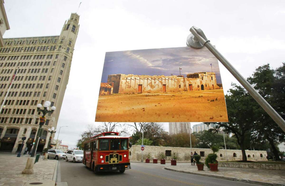 A rendering of the Alamo Long Barrack depicts the structure as it likely looked in 1836. This photo was taken Dec. 16, 2014, in front of the building as it is now.
