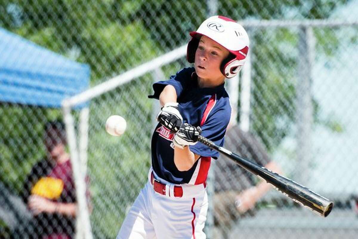 Fraternal Northwest's Gibson Brown hits the ball during the Little League Division 1 tournament at the Fraternal Northwest Little League Field in Midland on Sunday. (Danielle McGrew Tenbusch/for the Daily News)