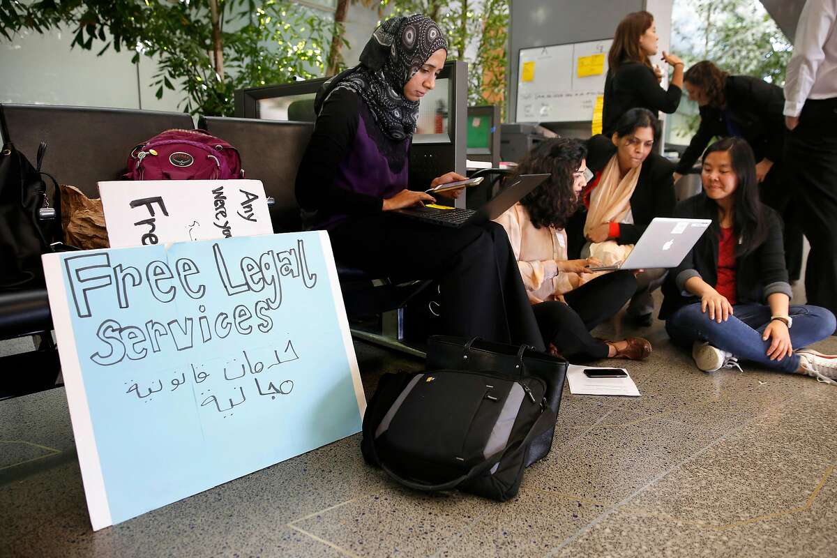 Several groups including Zahra Billoo, (center) with the Council on American-Islamic Relations offered free legal information to arriving passenger as the federal government implements the travel ban on people arriving from six mostly Muslin countries, at San Francisco International airport on Thursday June 29, 2017 in San Francisco, Ca.