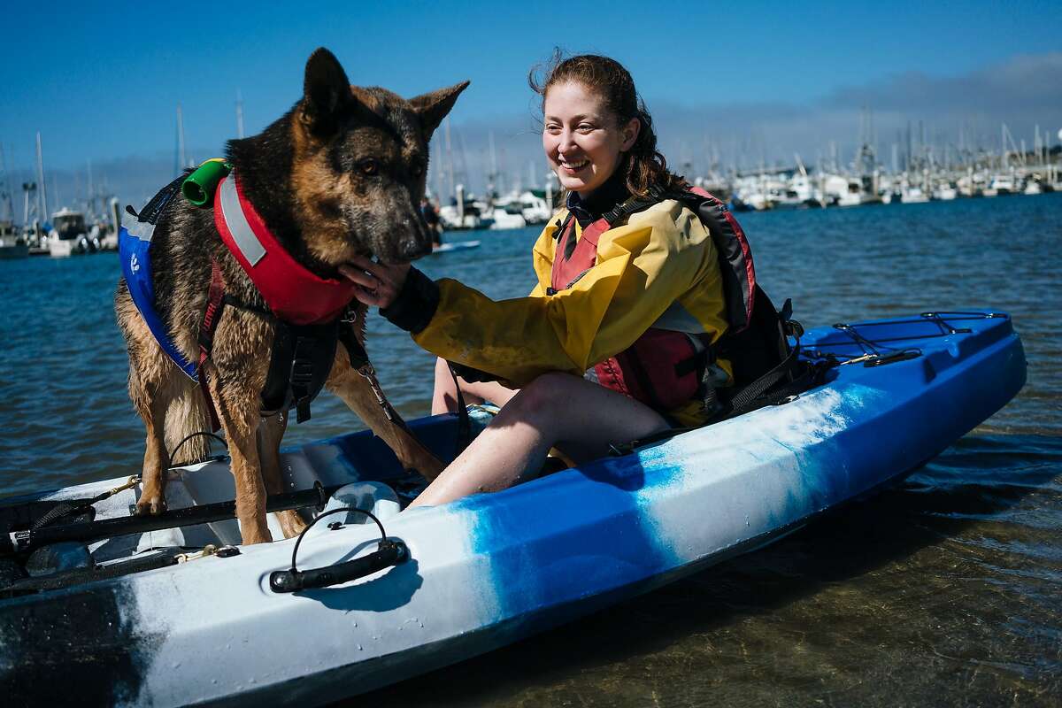 Alyssa Setnar of San Jose comforts her dog, Balto, as they attempt to his the waters of Pilar Point Harbor in Half Moon Bay, Calif., on Sunday, July 8, 2018.