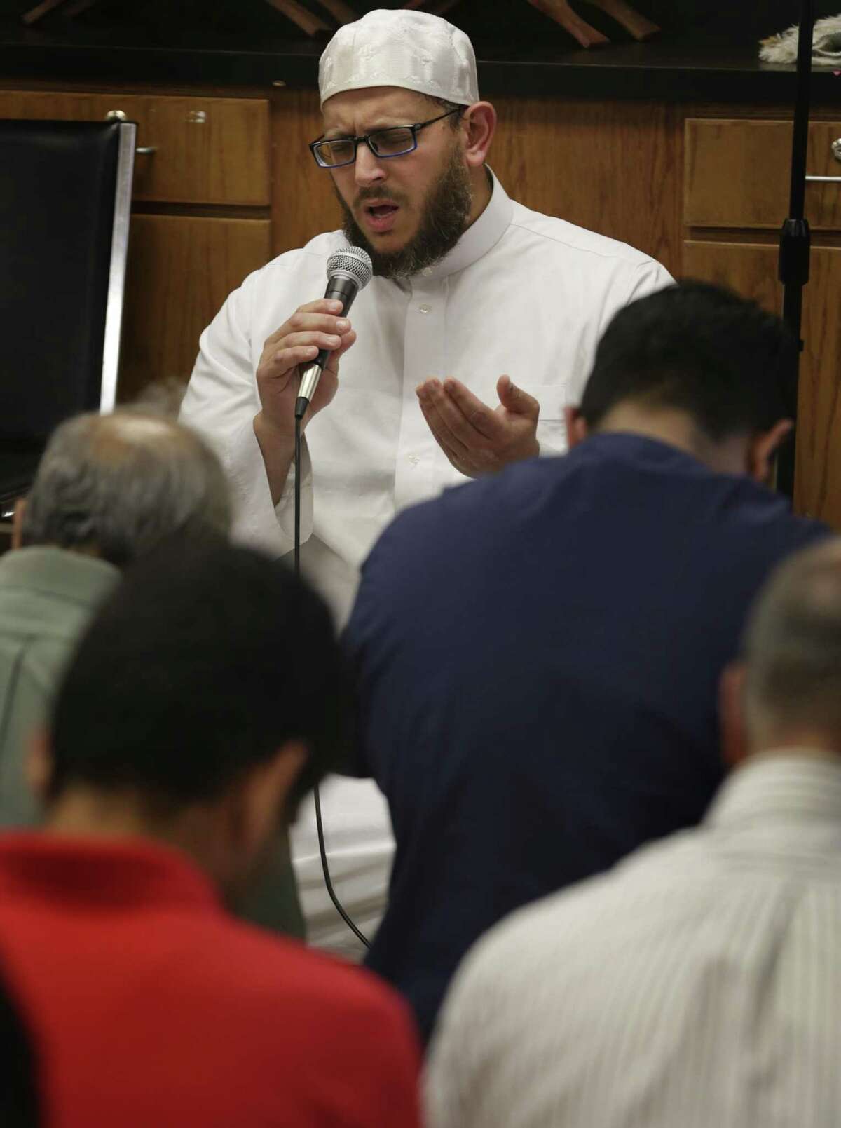 Imam Osama Hassan leads a prayer service at the Victoria Islamic Center in Victoria on Friday, Oct. 20, 2017.