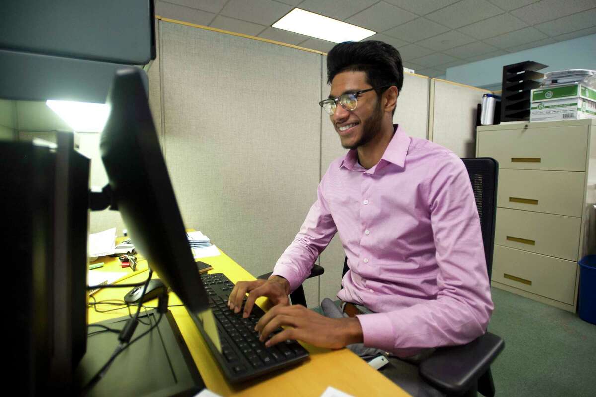 Ridwanoor Rashid, an intern in the city's Office of Policy and Management, poses for a photo at his desk inside Government Center in downtown Stamford, Conn. on Monday, July 9, 2018.