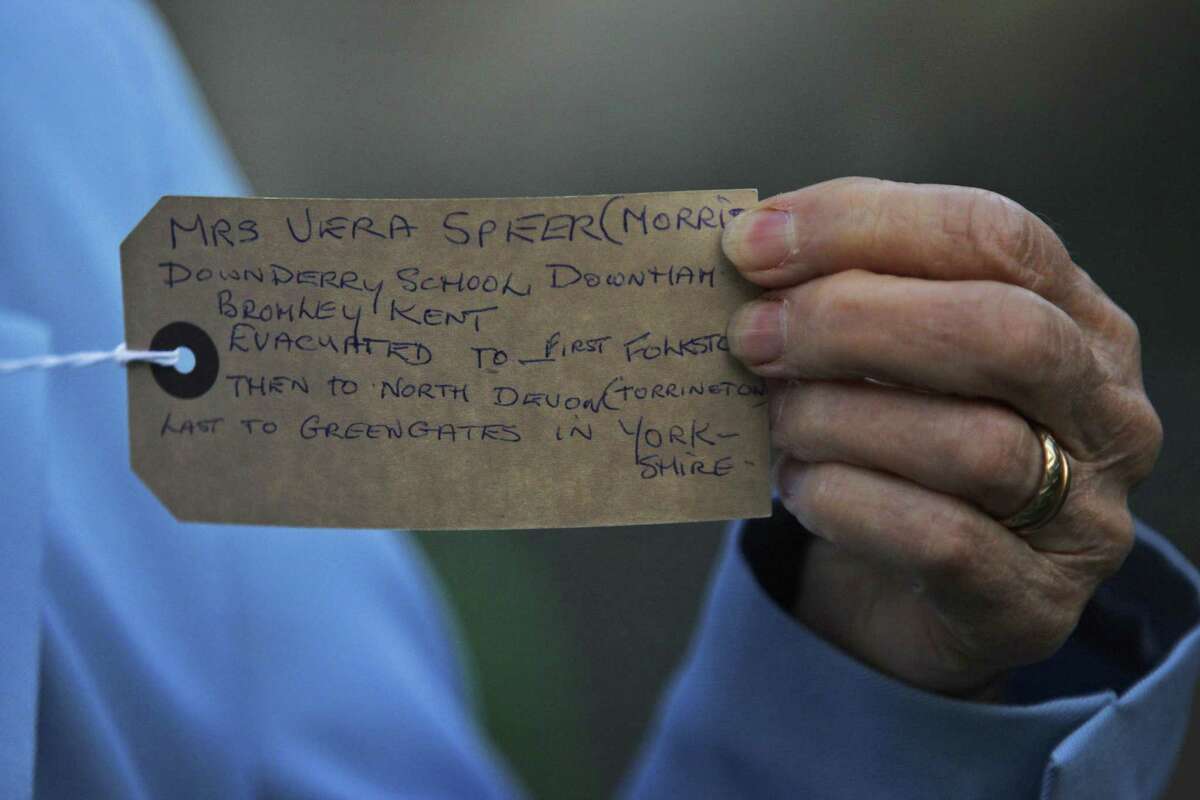 A former evacuee, shows a handwritten label with information about her name, her hometown and the towns she was evacuated to, during World War II, prior to a church service at St. Paul's Cathedral, commemorating the 70th anniversary of the first children to be evacuated, in central London, Tuesday Sept. 1, 2009. Organised by the Evacuation Reunion Association, hundreds of people gathered to mark the 70th anniversary of the evacuation of three million children in Britain ahead of the Second World War.