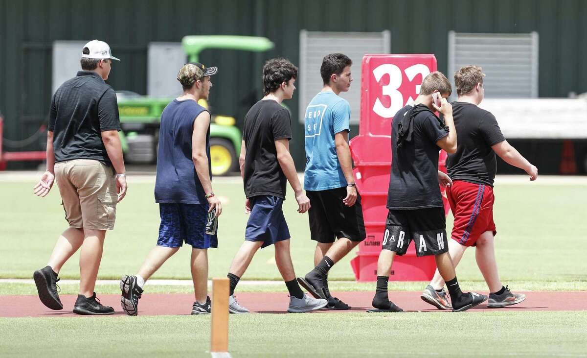 Santa Fe High School football players walk onto the Houston Texans practice field to watch mini camp at The Methodist Training Center on Tuesday, June 12, 2018, in Houston. The Santa Fe football players were invited guests of the Texans to watch practice. ( Brett Coomer / Houston Chronicle )