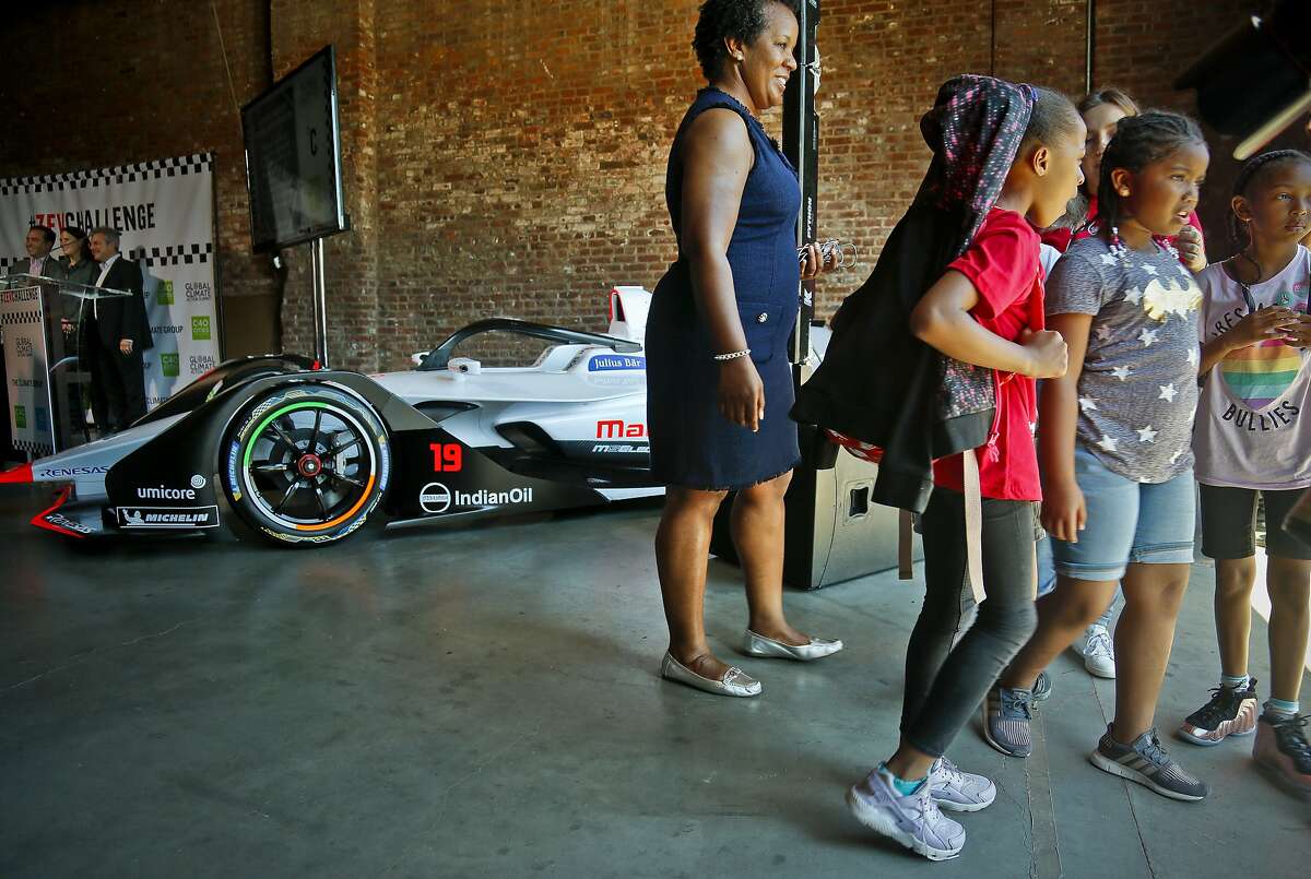 Summer camp youngsters leave after a brief viewing of a Generation 2 electric Formula-E racing car, following the announcement of a new initiative called Zero Emission Vehicle (ZEV) Challenge,Tuesday July 10, 2018, in New York. Helen Clarkson, CEO of The Climate Group, announced the ZEV Challenge, a program to accelerate the global adoption of electric vehicles, during a press conference and panel discussion. The Formula E season finale auto race is Sunday in the Red Hook neighborhood in the borough of Brooklyn. (AP Photo/Bebeto Matthews)