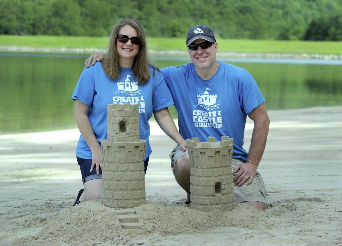 Laurie and Kevin Lane of New Milford invented a new system for building sand castles and snow sculptures. Photo at Lynn Deming Park in New Milford, Thursday, June 22, 2017.