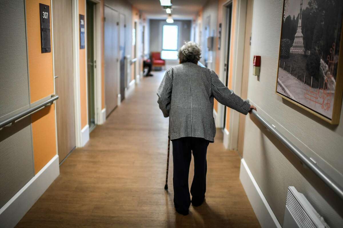 An elderly resident walks in a corridor on July 5, 2018, in an establishment of accommodation for dependent old persons (EHPAD) in Paris. / AFP PHOTO / STEPHANE DE SAKUTINSTEPHANE DE SAKUTIN/AFP/Getty Images