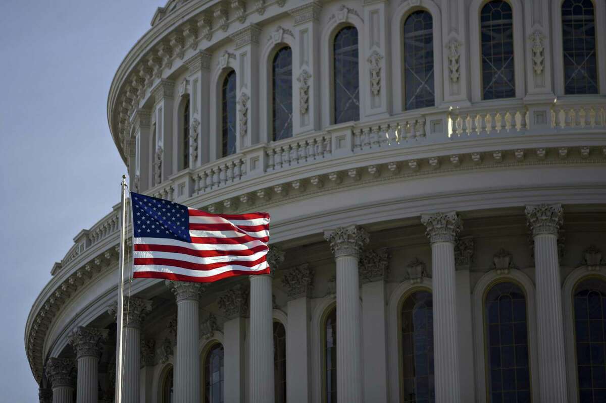 The American flag flies next to the dome of the U.S. Capitol building on Jan. 15, 2017.