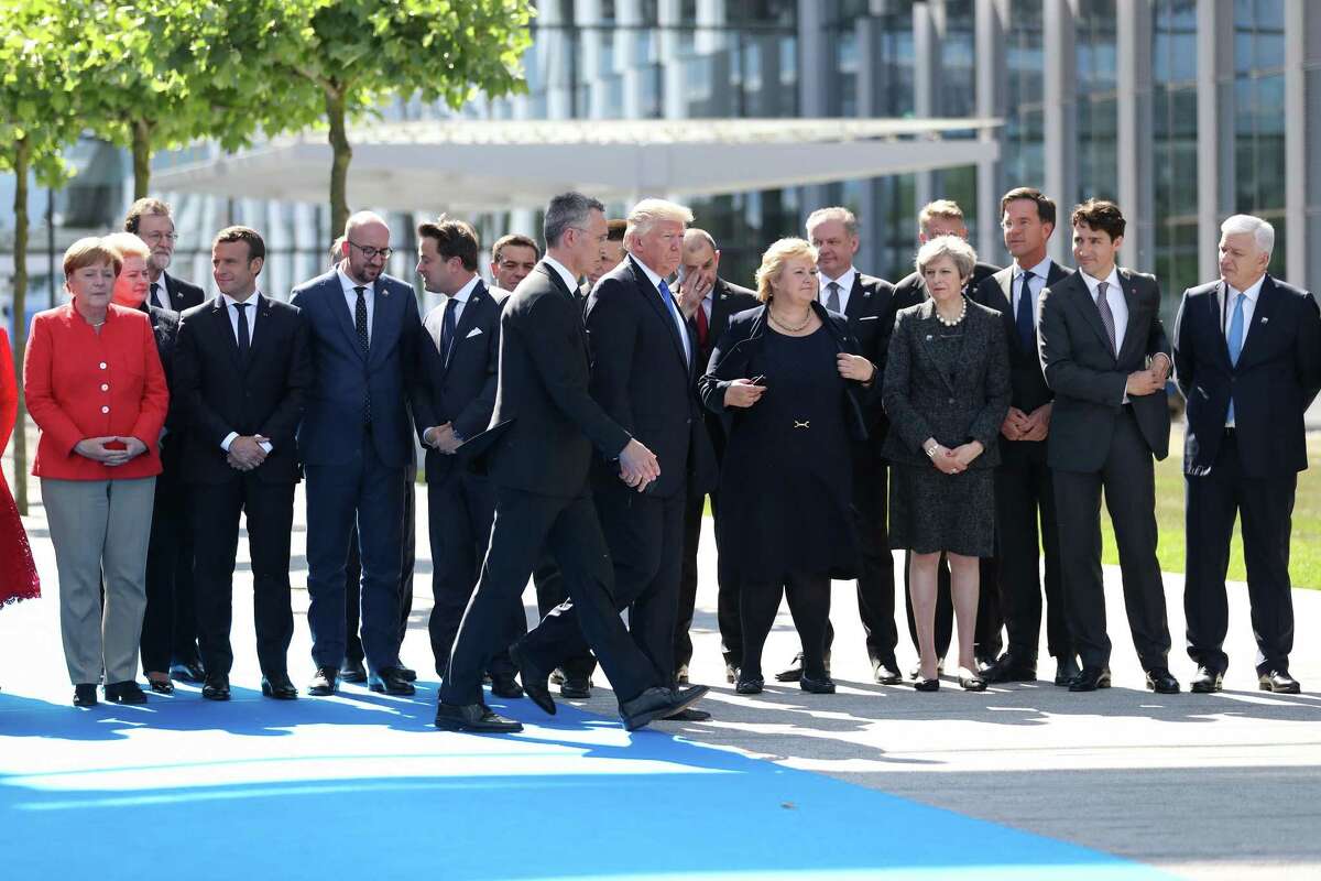 President Donald Trump (center) walks with Jens Stoltenberg, secretary general of the North Atlantic Treaty Organization, as world leaders gather for a group photograph during a summit at the NATO headquarters in Brussels on May 25, 2017. MUST CREDIT: Bloomberg photo by Jasper Juinen.