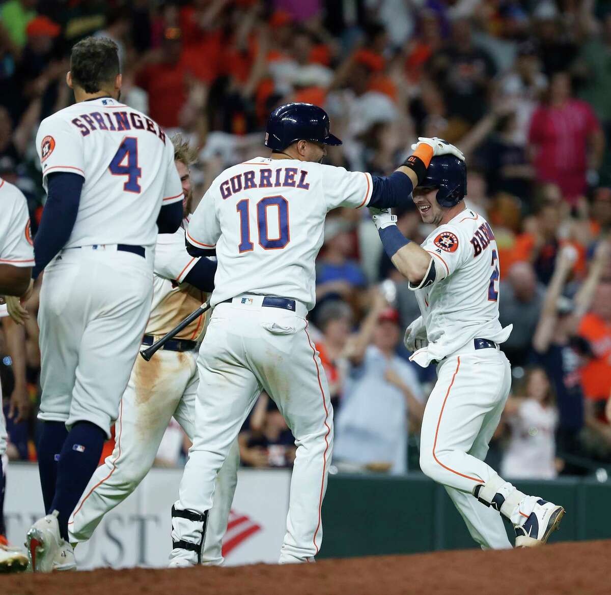 Houston Astros Alex Bregman (2) celebrates after Bregman reached on a single allowing Kyle Tucker to score the winning run during the eleventh inning of an MLB game at Minute Maid Park, Tuesday, July 10, 2018, in Houston.