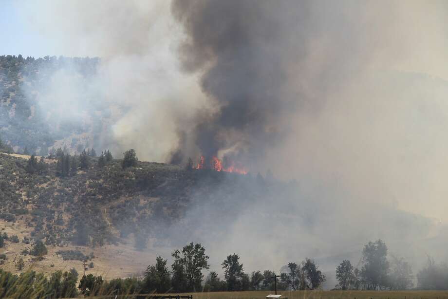 In this photo taken Thursday, July 5, 2018, the Klamathon Fire burns near Copco Road in Hornbrook, Calif. The wildfire burning through drought-stricken timber and brush near California's border with Oregon has killed one person and destroyed multiple structures. (Danielle Jester/Siskiyou Daily News via AP) Photo: Danielle Jester / Associated Press