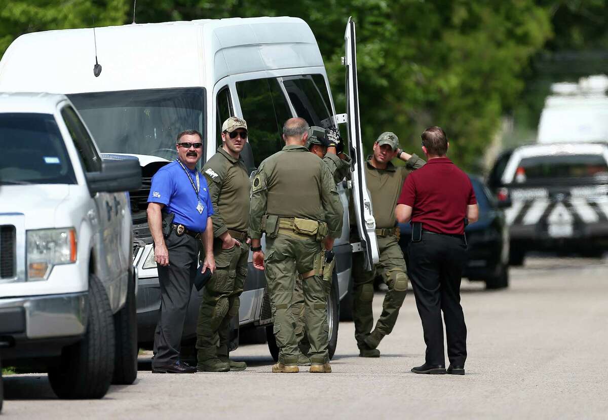 Authorities investigate the scene where a Homeland Security agent shot a suspect during a morning raid on the 6100 block of Grapevine Street Wednesday, July 11, 2018, in Houston. The male suspect was transported to the hospital with a single gunshot wound to the lower abdomen. Authorities removed vehicles from the property.