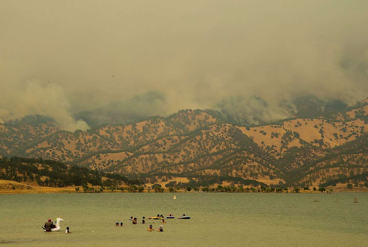A wildfire burns near Lake Berryessa in Napa, Calif., Sunday, July 1, 2018. Smoke from the Yolo County fire was contributing to poor air quality in Napa, Sonoma, San Mateo and San Francisco counties, according to the National Weather Service. (Paul Kitagaki Jr./The Sacramento Bee via AP)