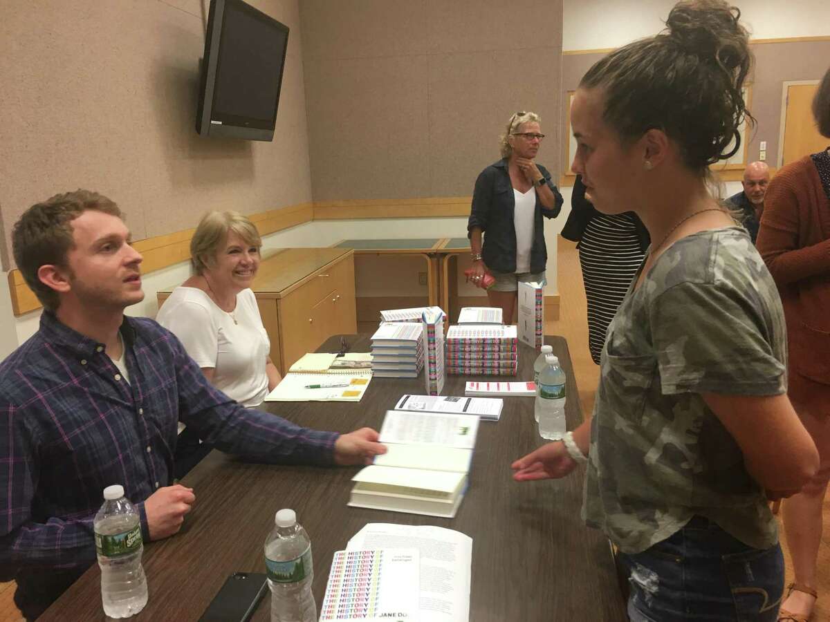 Greenwich High School sophomore Kira Popa chats with history teacher and young adult author Michael Belanger about his new book, “The History of Jane Doe,” after his author talk Tuesday evening at Greenwich Library.