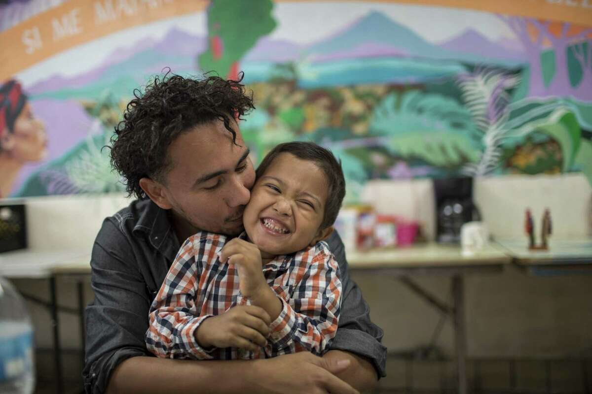 Roger and his 4-year-old son Roger Jr, (only first names given) embrace before a press conference at the Annunciation House, Wednesday, July 11, 2018, in El Paso, Texas. After being separated by CBP in February, the two were reunited and released by ICE late last night. Photo by Ivan Pierre Aguirre