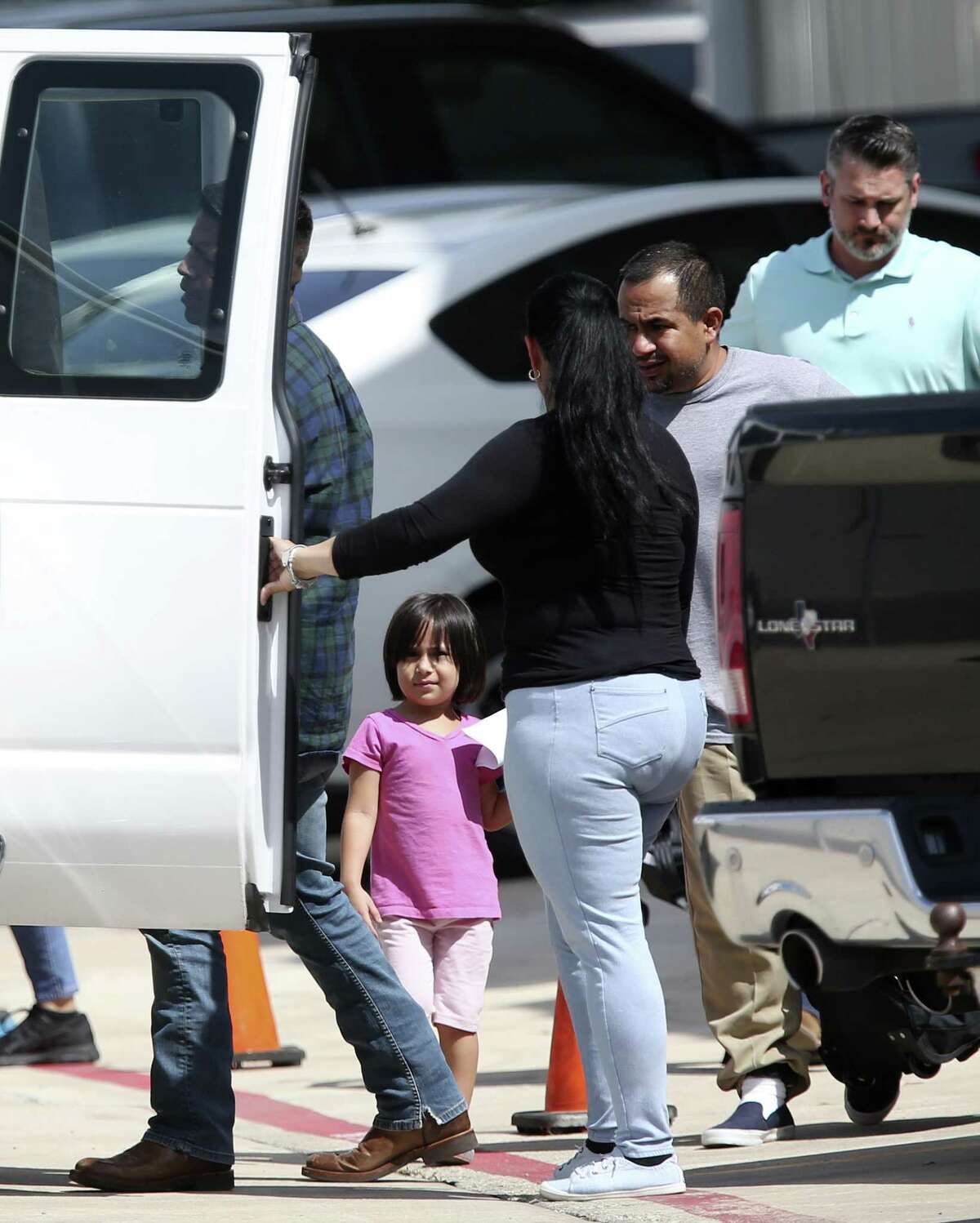Immigrant families leave a U.S Immigration and Customs Enforcement facility after they were reunited overnight in San Antonio, Wednesday, July 11, 2018. The two vans headed to the Archdiocese of San Antonio Catholic Charities offices. Several immigrant families were seen in the vans.