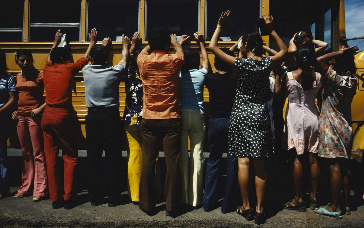 Bus passengers in Ciudad Sandino, Nicaragua, are searched in 1978, a standard practice for travelers.