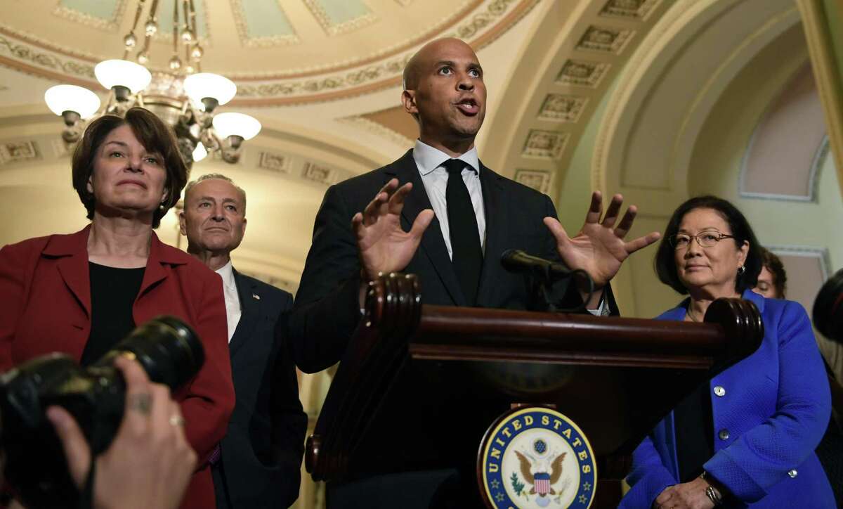 Sen. Cory Booker, D-N.J., center, speaks to reporters on Capitol Hill in Washington, Tuesday, July 10, 2018. Booker is joined by, from left, Sen. Amy Klobuchar, D-Minn., Senate Minority Leader Sen. Chuck Schumer of N.Y., and Sen. Mazie Hirono, D-Hawaii. (AP Photo/Susan Walsh)