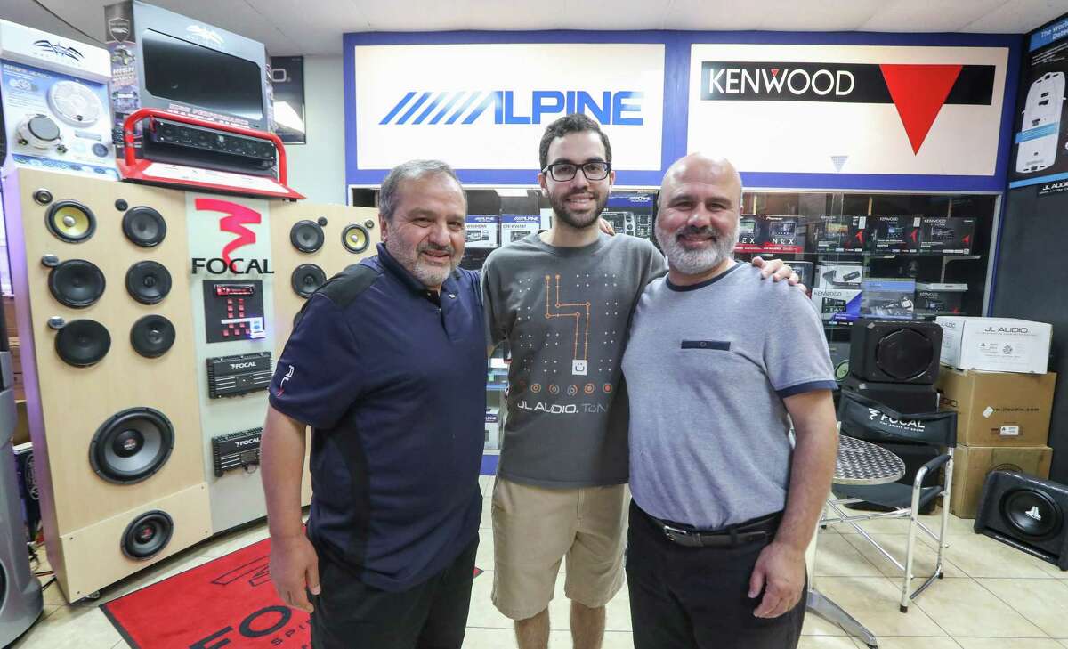 Mohamed Almasri, (left-right) Mohamod and his father, Dia Almasri of Houston Car Stereo pose for a photo Thursday, July 12, 2018, in Houston.