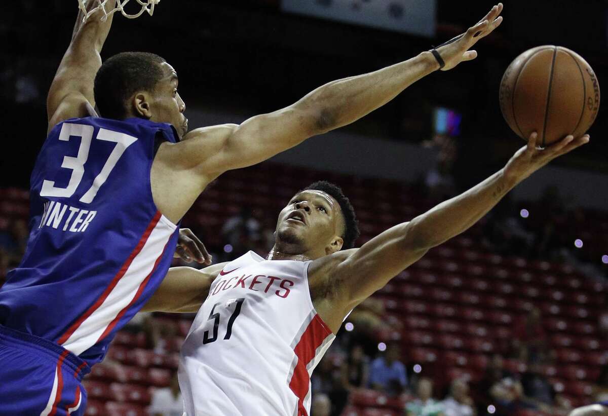 Houston Rockets' Trevon Duval, right, attempts to shoot around Los Angeles Clippers' Vincent Hunter during the second half of an NBA summer league basketball game, Monday, July 9, 2018, in Las Vegas. (AP Photo/John Locher)