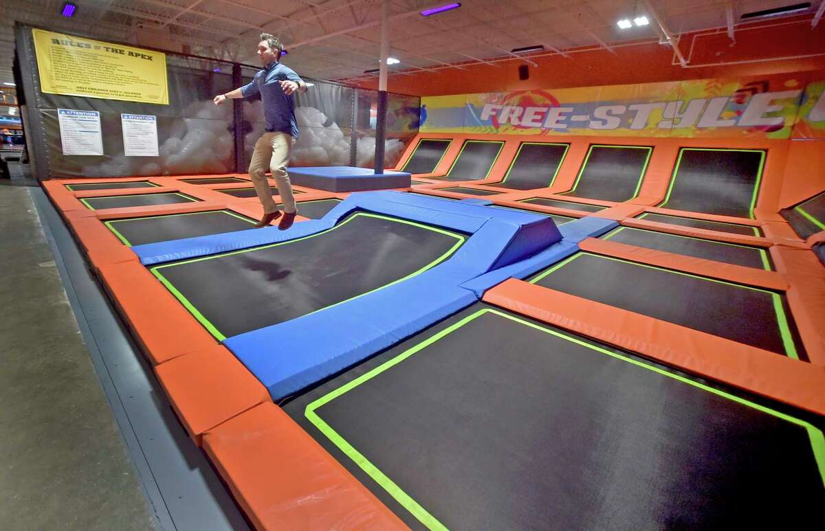 Orange, Connecticut - Thursday, July 12, 2018: Urban Air Trampoline and Adventure Park corporate vice-president of marketing Josh Tate, demonstrates one of many trampolines in approximately 85,000 square feet of what Urban Air calls "the ultimate adventure park" on Bull Hill Lane in Orange. Urban Air, based in Texas, includes go carts that can reach 30 mph on a strait away, arcades, bowling, themed trampoline areas, a ninja warrior-style adventure course, a tube obstacle course, multiple climbing walls, a virtual reality game system, laser tag, modernized bumper cars, dodge ball, a unique "Sky Rider" coaster, a cafe among other amusements. The opening of Urban Air is scheduled for Saturday, July 14th.
