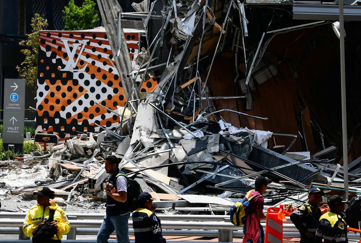 Police officers secure the area in front of a shopping mall that partially collapsed for unknown causes, in Mexico City on July 12, 2018. (Photo by RONALDO SCHEMIDT / AFP) (Photo credit should read RONALDO SCHEMIDT/AFP/Getty Images)