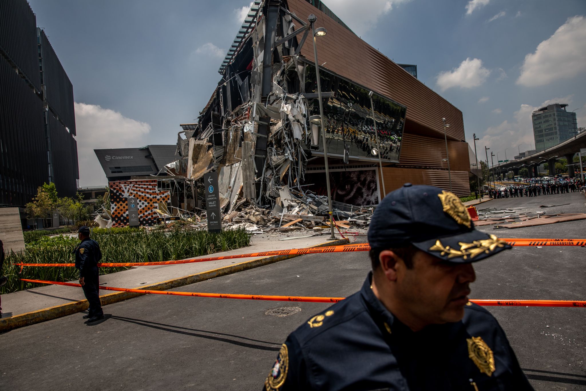 Fallen sections of the Artz Pedregal shopping mall lie on the