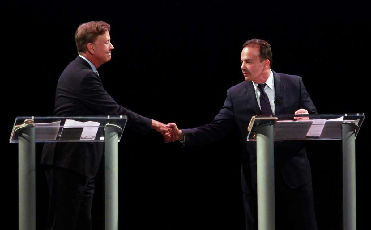 Ned Lamont, left, shakes hands with Bridgeport Mayor Joe Ganim before the start of the first Democratic debate for governor at the Shubert Theater in New Have on Thursday.