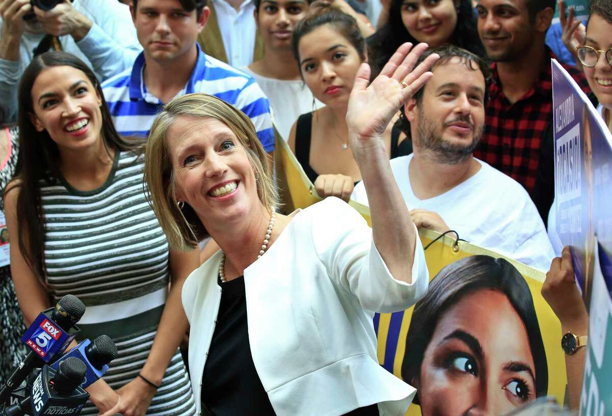 Alexandria Ocasio-Cortez, left, the surprise winner in the congressional race who unseated 20-year incumbent Joe Crowley in New York's Congressional District 14, stands next to Zephyr Teachout, center, during a press conference after endorsing her candidacy for Attorney General, Thursday, July 12, 2018, in New York. (AP Photo/Bebeto Matthews)