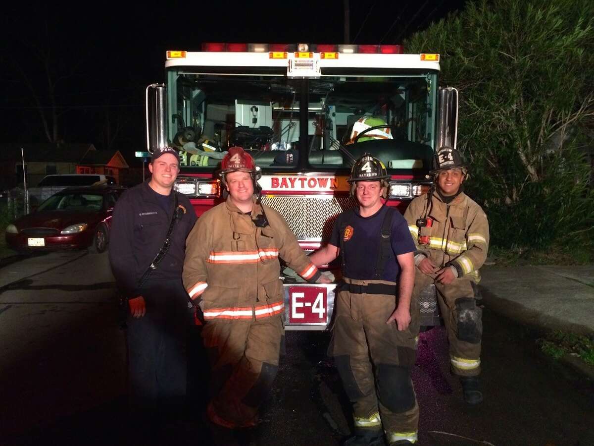 Baytown firefighter Patrick Mahoney (second from left) is being sued by the city of Baytown to deny him coverage for his cancer treatment.
