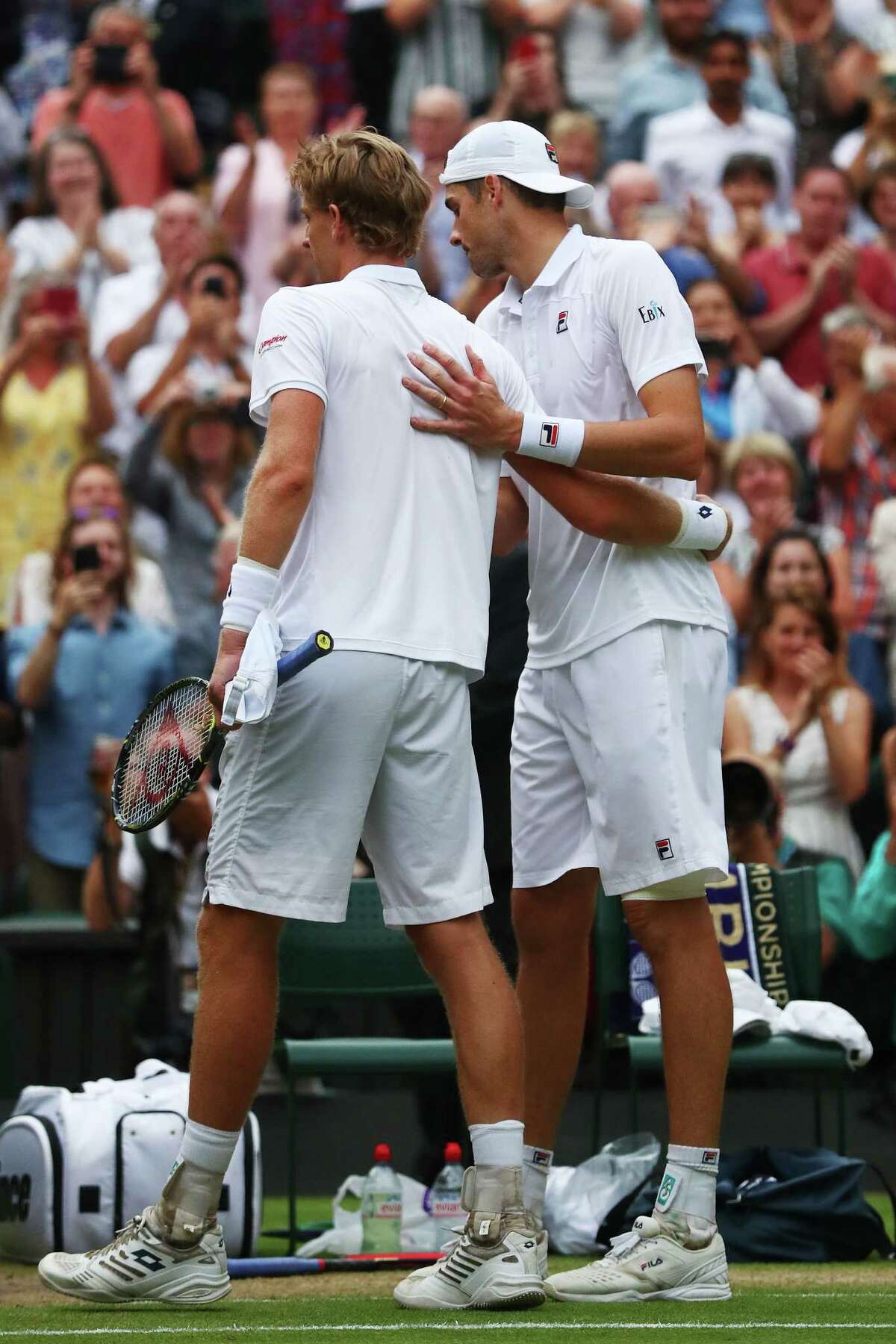 LONDON, ENGLAND - JULY 13: Kevin Anderson of South Africa (L) hugs John Isner of The United States after their Men's Singles semi-final match on day eleven of the Wimbledon Lawn Tennis Championships at All England Lawn Tennis and Croquet Club on July 13, 2018 in London, England.
