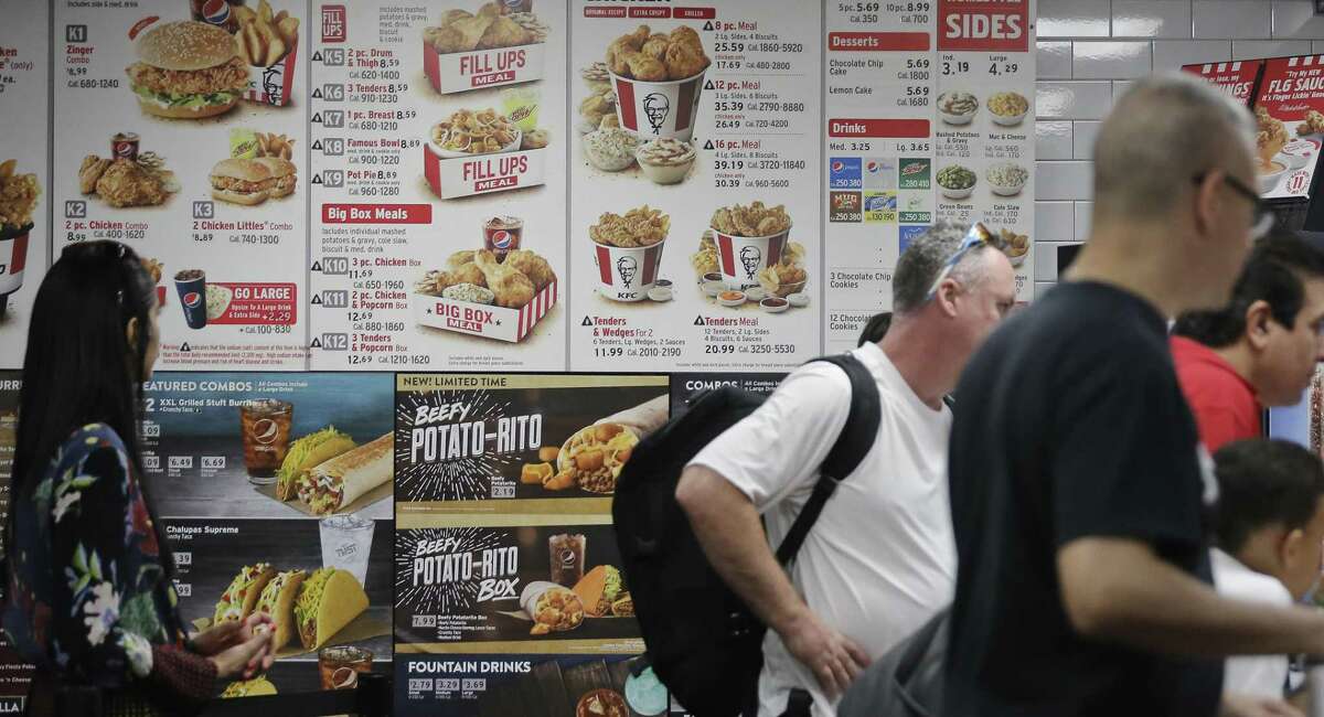A nationwide law requiring establishments that sell prepared foods and have 20 or more locations to post the calorie content of food went into effect in May. The change is intended to help consumers avoid “calorie bombs” when they go out to eat. This image shows a KFC menu board in New York, which has had menu labeling laws since 2006.