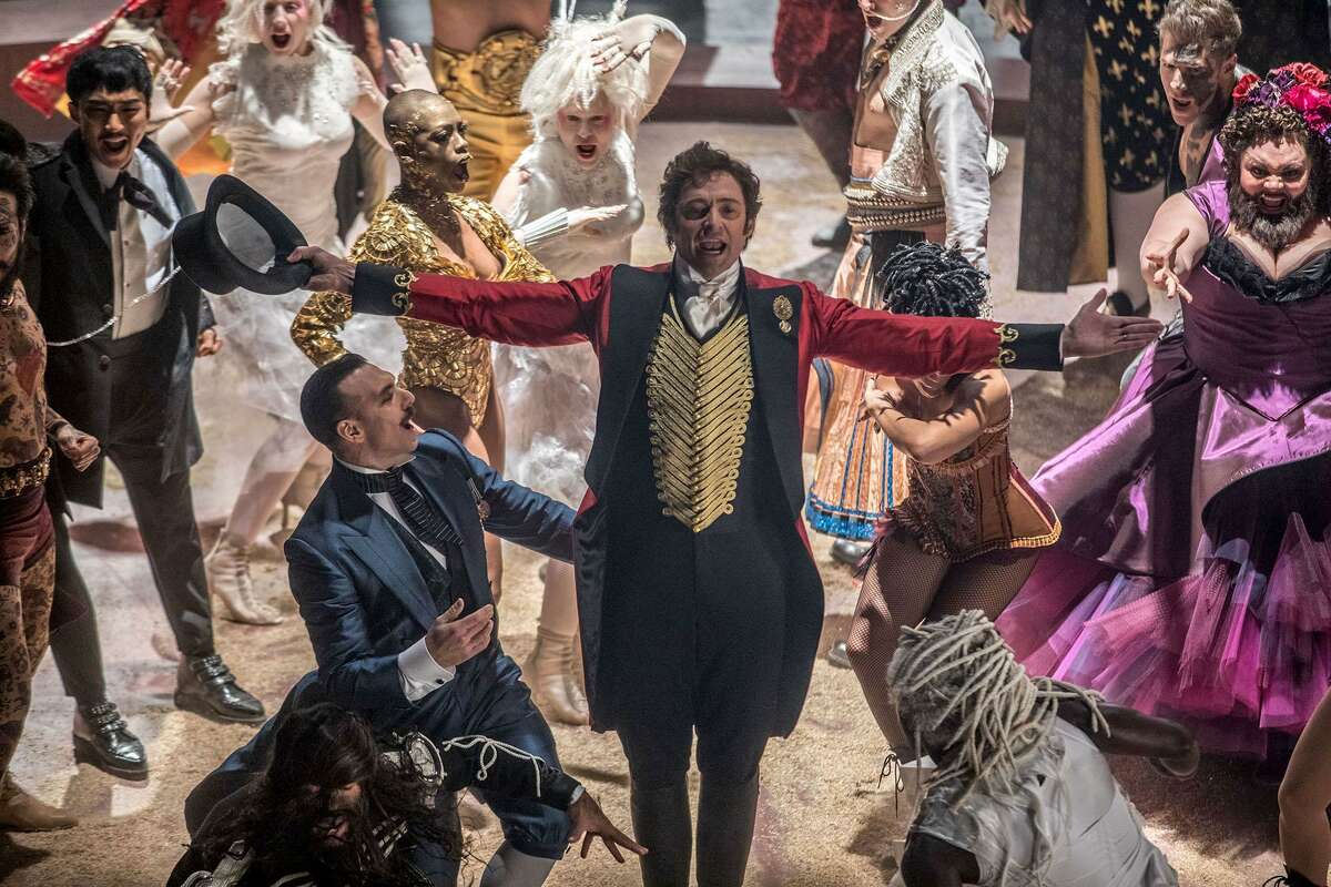 Hugh Jackman, center, plays huckster and circus founder P.T. Barnum in the musical "The Greatest Showman." MUST CREDIT: Niko Tavernise, Twentieth Century FoX