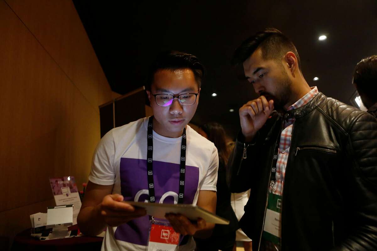Joshua Lau, left, a Purple Go intern, speaks to Ben Liu at the 500 Startups Demo Day at Bespoke in the Westfield San Francisco Centre on Thursday, June 28, 2018 in San Francisco, Calif.