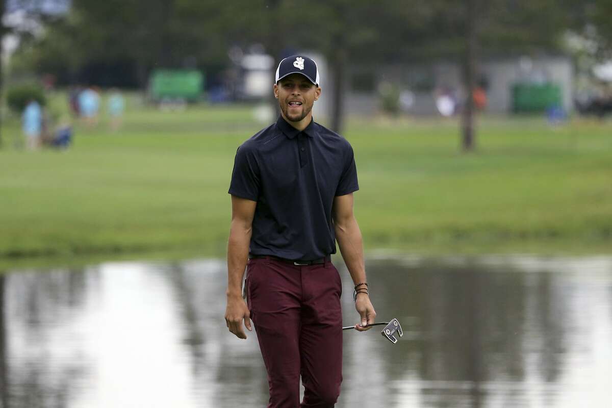 Golden State Warriors NBA basketball player Stephen Curry walks up the second fairway during the first round of the American Century Championship golf tournament at the Edgewood Tahoe Golf Course in Stateline, Nev., Friday, July 13, 2018. (AP Photo/Lance Iversen)