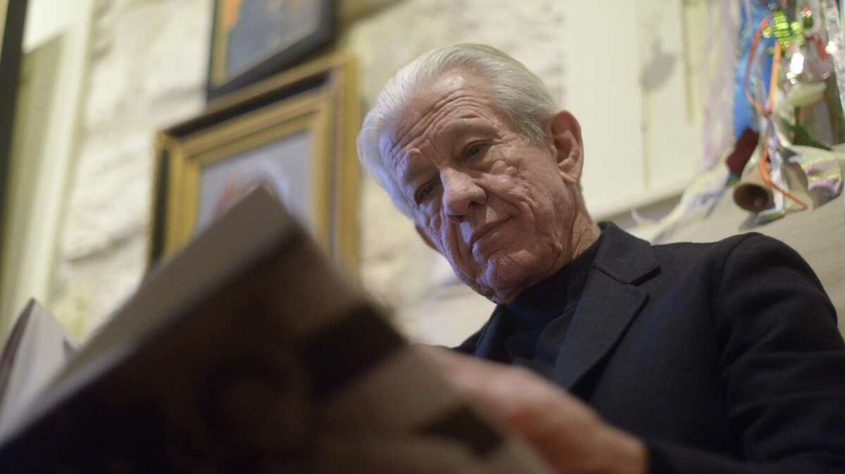 Lionel Sosa, a businessman and advertising consultant, leafs through a book in his studio in 2015. He is newly appointed as one of three chairmen of the Alamo Citizen Advisory Committee.